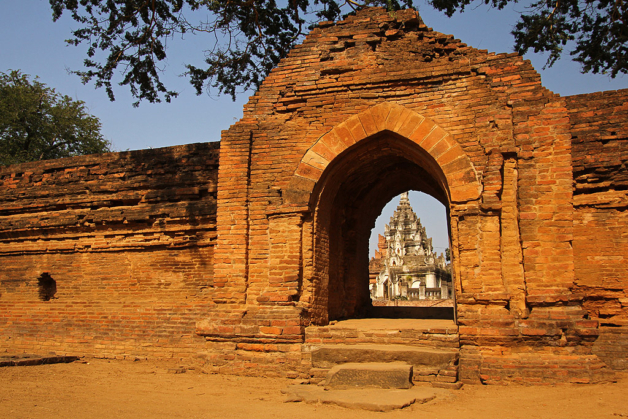 Myanmar view of temple through brick archway wall